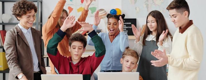 Learners in a classroom celebrating together with the Thuto app